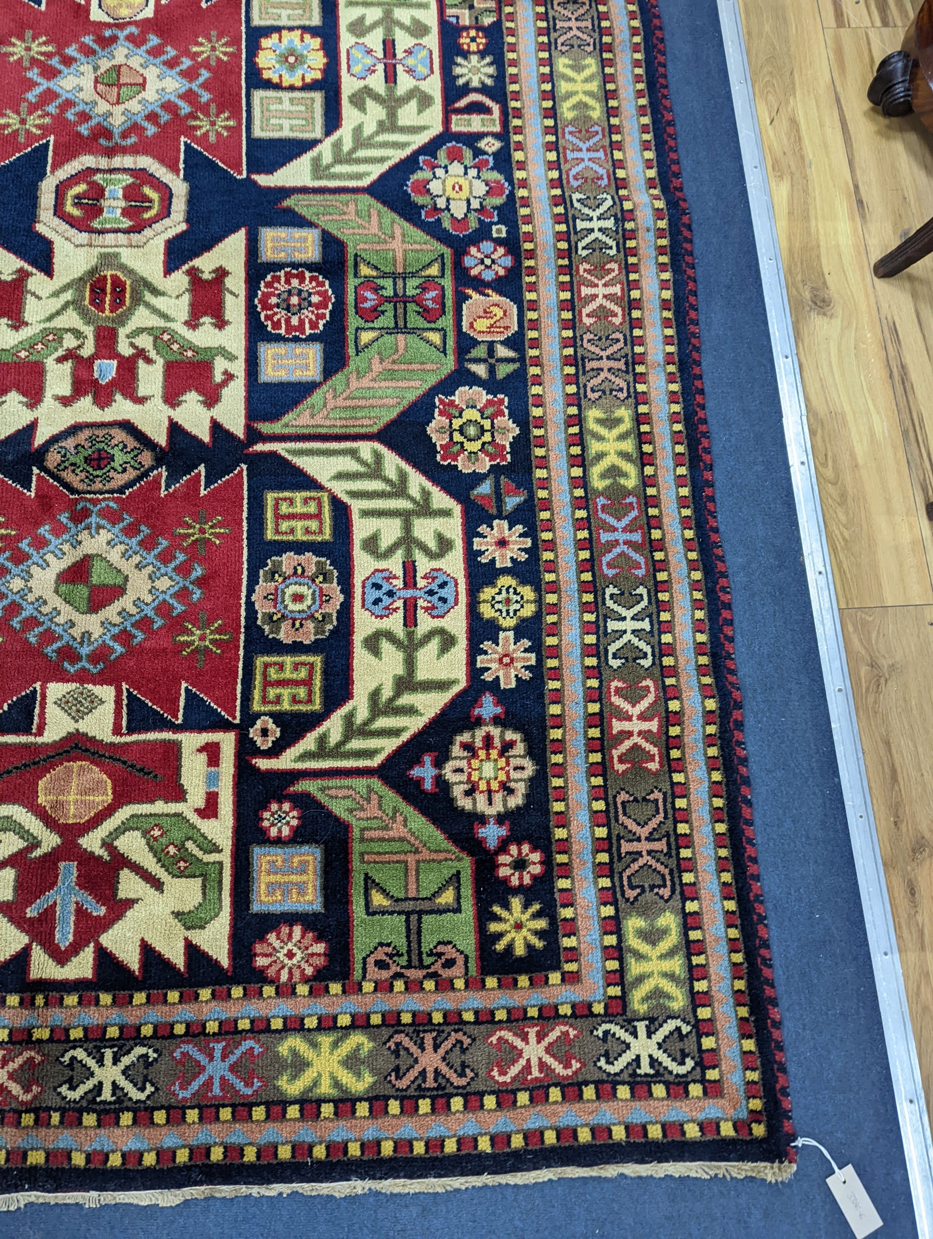 A Caucasian blue ground rug, 240 x 176cm